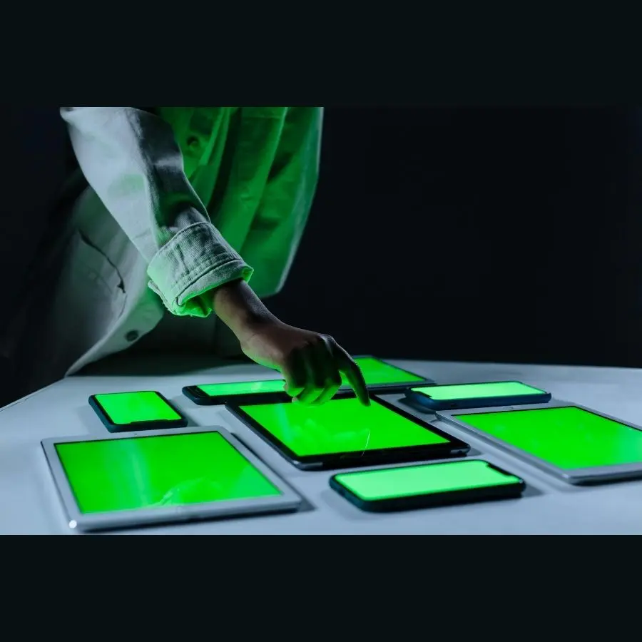 Person tapping on green glowing tablet looking at digital IDs