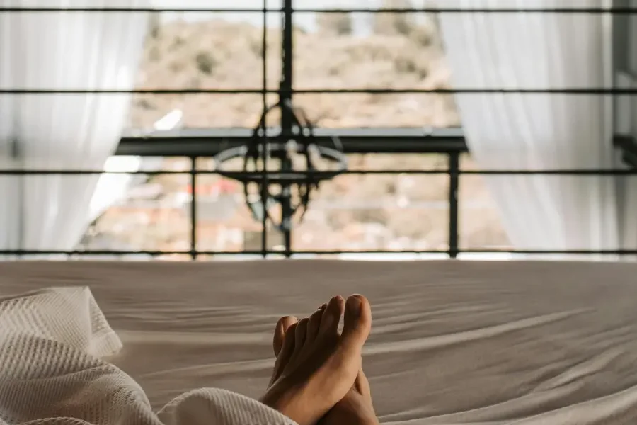 Person enjoying the light streaming through the window